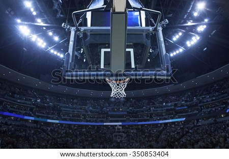 Brightly lit Basketball backboard in a large sports arena.