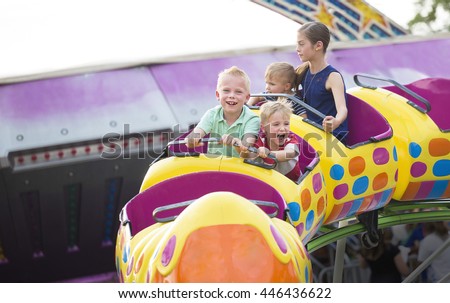Kids on a thrilling roller coaster ride at an amusement park