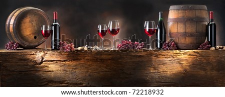 still life with red wine and barrel on old wood