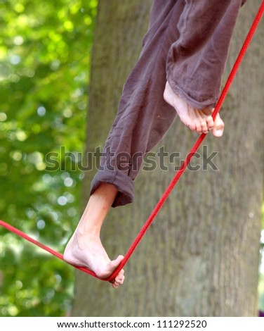 tightrope walker performes in the park