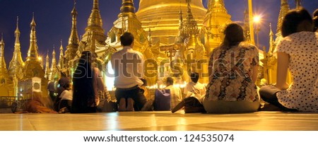 YANGOON, MYANMAR - NOVEMBER 2 ; Devoted people are praying at the shwedagon pagoda on Nov. 5, 2011 Yangoon, Myanmar.This Shwedagon in Yangoon is the most holy and biggest of the whole country