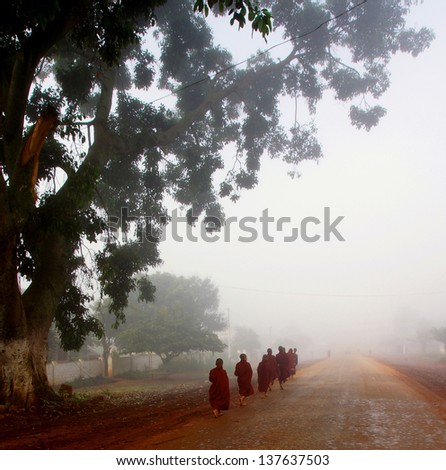 HEHO,MYANMAR - NOV. 28; Unidentified monks gathering offers on Nov.28, 2012 Myanmar.The first two monks carrying food on plates. This way of gathering offers is rarely seen anymore in Myanmar.