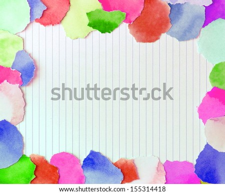 colorful border from torn pieces of paper surrounding a piece of writing paper