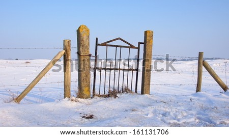fence with gate in wintertime covered with ice