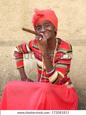HAVANA, CUBA -FEBR 8; Unidentified woman with a cigar on februari 8, 2013 in Havana. The african culture  has a huge influence in Cuba where approximately 50% of the population is of african descent