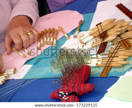 handcraft demonstration of traditional lace ,  hands making bobbin lace