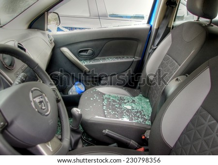 Thiefs have broken a car window to steel items inside  and the glass is spread all over the car seats