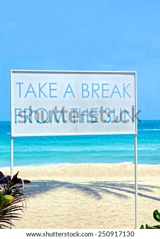 Big sign standing on the beach with the words ; \