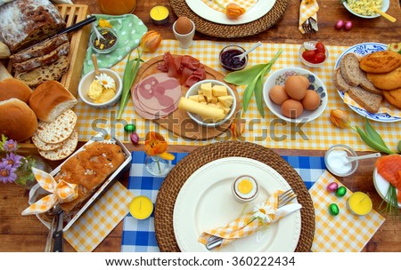 breakfast or brunch table setting  full of healthy ingredients for a delicious easter meal with friends and family around the table