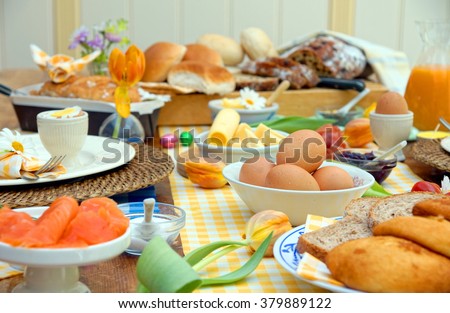 breakfast or brunch table setting full of healthy ingredients for a delicious easter meal with friends and family around the table