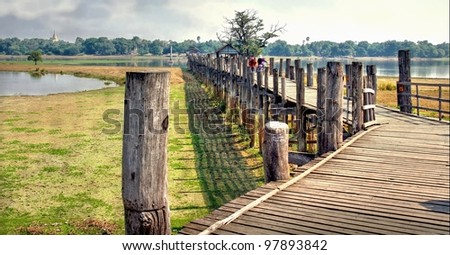 landscape in asia with a wooden bridge crossing the river