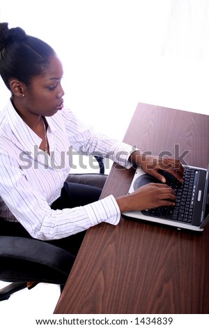 Acrican American Woman With Computer Sitting At Desk
