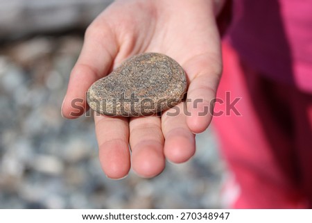Girl holding pebble in hand