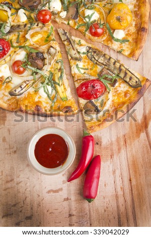 vegetable italian pizza with hot sauce