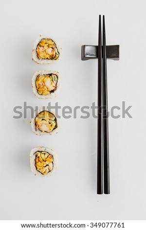 sushi roll, chopstick and sauce