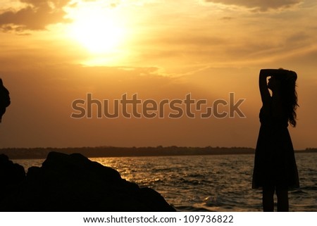 This is a view of shadow of alone woman on the rock