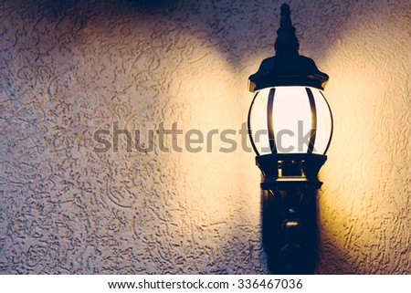 Light fixture lamp lit up on a textured wall in matte finish