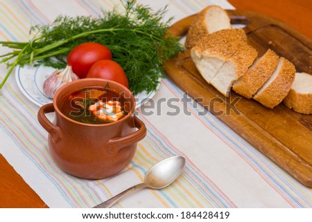 Ukrainian soup and bread with vegetables on  towel