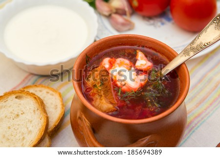 Ukrainian soup and bread with vegetables on  towel