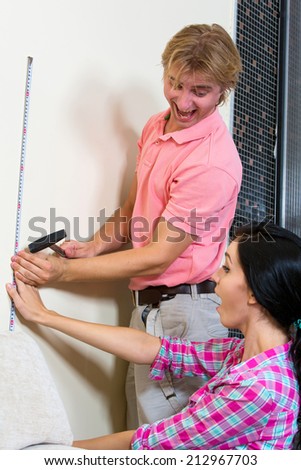 Young couple engaged in small home repairs