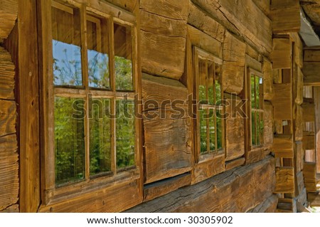 Wall and windows of old, wooden house is in the country