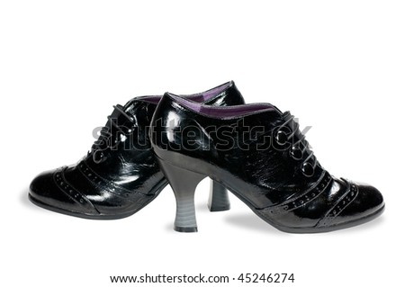 Women\'s black patent leather shoes isolated on white.