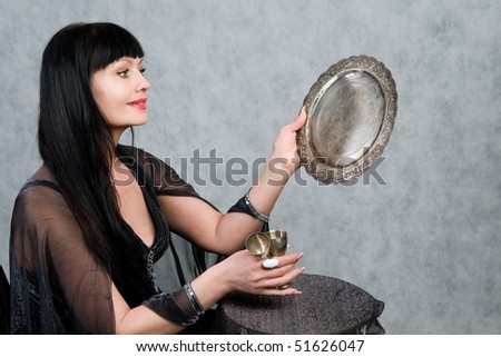 Beautiful woman of forty-five years   and silver wineglass