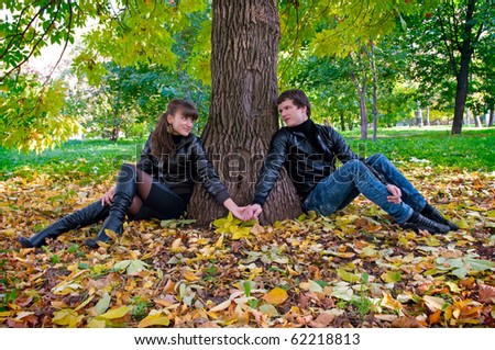 A young couple on a walk in autumn park