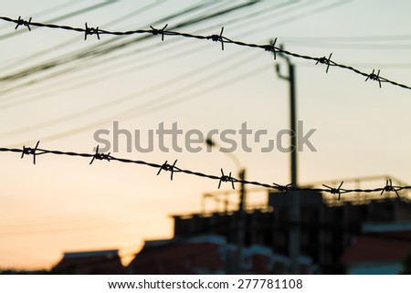 first silhouettes line Barbed with Evening sky