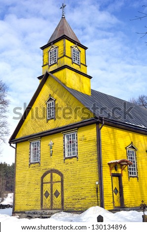 Folk architecture forms, wooden yellow Silenai Church of the Virgin Mary stands Silenai village, 16 km west of Vilnius.