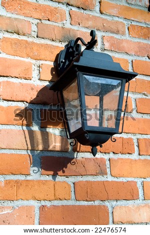 Wrought lantern hanging from a brick wall