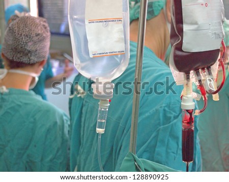 Transfusion and infusion at surgery, team of doctors