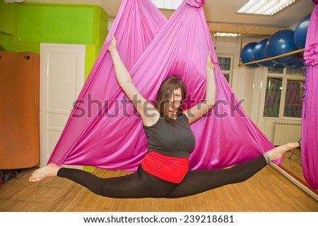 Aerial yoga practicing - anti gravity yoga with scarves