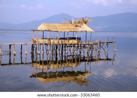 Fishermen`s village with houses made of cane and wooden docks in southern Europe.