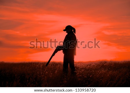 Woman Upland Game Hunter and Shotgun in Sunset