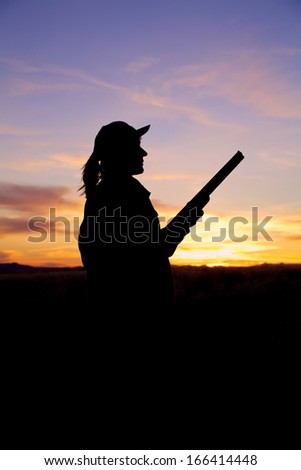 Hunter With Shotgun Silhouetted at Sunrise
