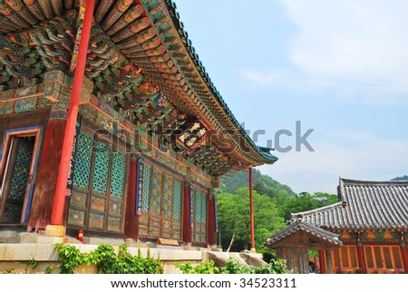 Korean-styled detailed architecture of the main building and pavilion with blue sky background