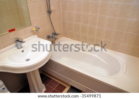 Dry, clean bathtub and wash basin in a luxurious hotel room