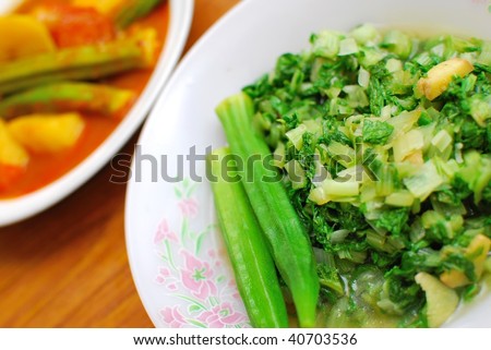Simple, home cooked Chinese vegetarian cuisine. Ingredients include green, leafy vegetables, and lady fingers. Suitable for food and beverage, travel, healthy lifestyle, and diet and nutrition.