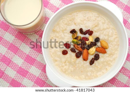 Cereal and soya bean milk for a healthy and nutritious breakfast. Topped with nuts and raisins. Suitable for diet and nutrition, healthy eating and lifestyle, and food and beverage concepts.