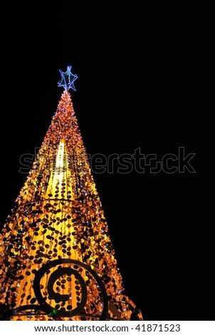 Christmas tree lit up with decorations and colorful lights. Suitable for winter seasons, christmas and holiday concepts.