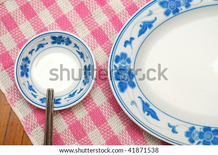 Dining table set with Chinese style oriental utensils. For food and beverage, diet and nutrition concepts.