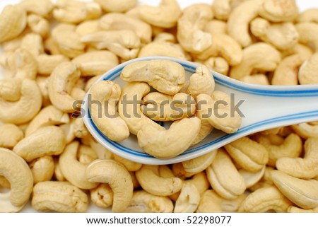 Spoonful of cashew nuts. Signifying food and beverage, and healthy and nutritious eating.