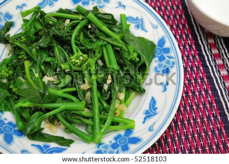 Green leafy vegetables stir fried and cooked oriental style. For concepts such as food and beverage, diet and nutrition, and healthy eating.