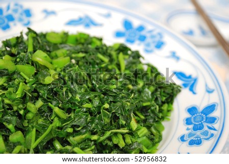 Simple green leafy vegetables from the Brassica Rapa family cooked Chinese style. For concepts such as food and beverage, diet and nutrition, and healthy eating.