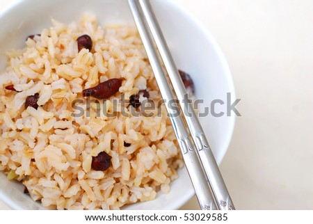 Cooked, red unpolished rice commonly eaten in Asian countries such as Japan and China. For diet and nutrition, healthy eating and lifestyle concepts.