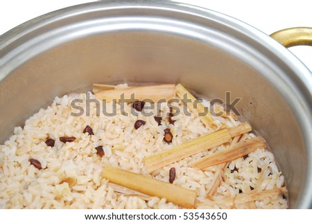 Healthy unpolished red rice and beans in rice pot isolated on white background. Suitable for concepts such as diet and nutrition, healthy lifestyle, and food and beverage.
