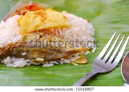 Malay traditional delicacy known as nasi briyani packed in banana leaf. Suitable for concepts such as diet and nutrition, healthy lifestyle, and food and beverage.