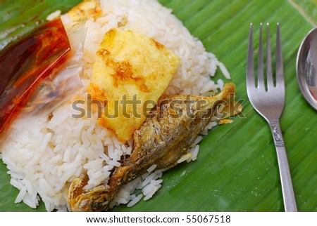 Malay traditional delicacy known as nasi briyani packed in banana leaf. Suitable for concepts such as diet and nutrition, healthy lifestyle, and food and beverage.