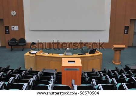 Lecture theater showing white screen. For concepts such as school and education, business and training, and meetings and conferences.